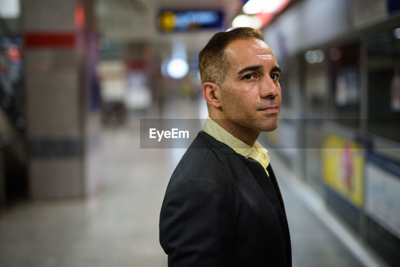 Man standing at railroad station