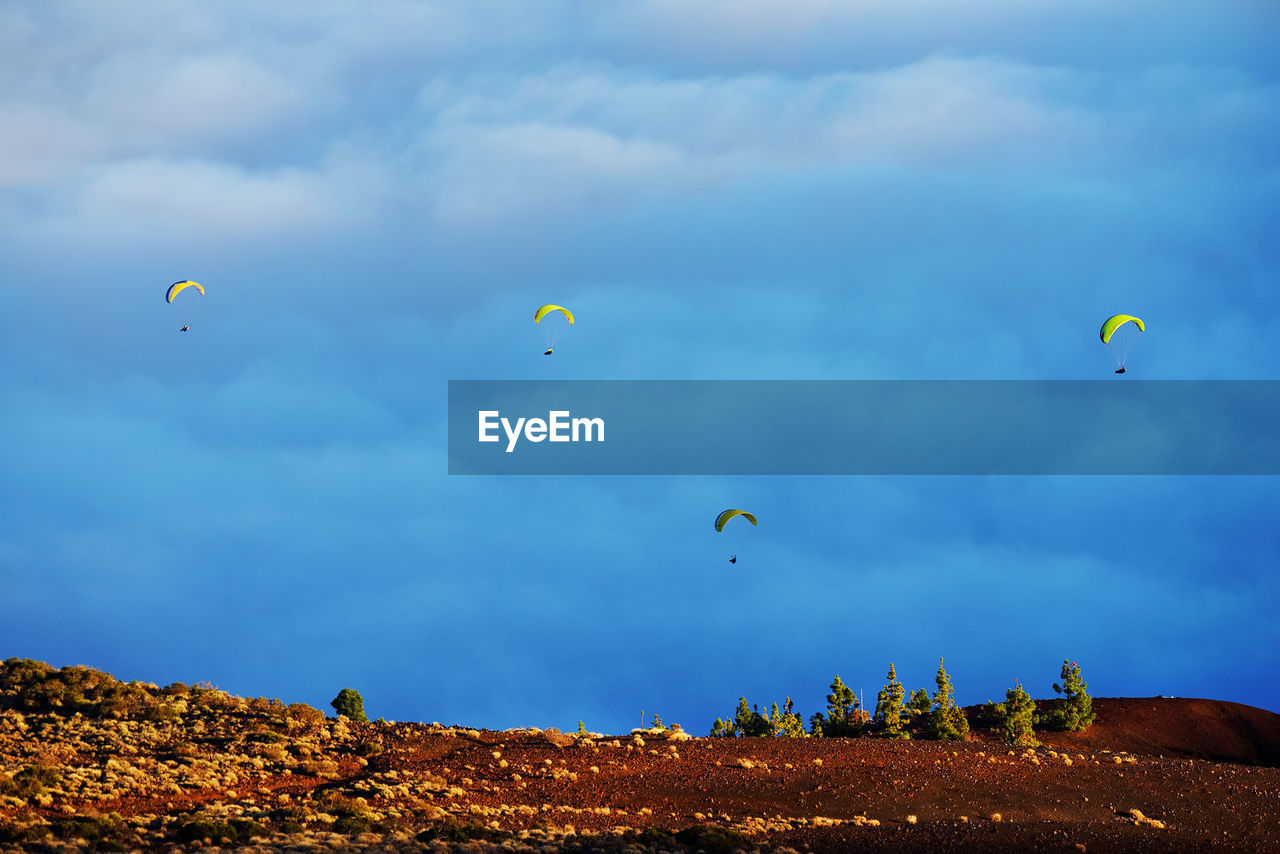 People paragliding over el teide national park