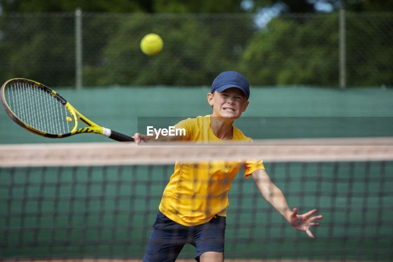 Boy playing tennis