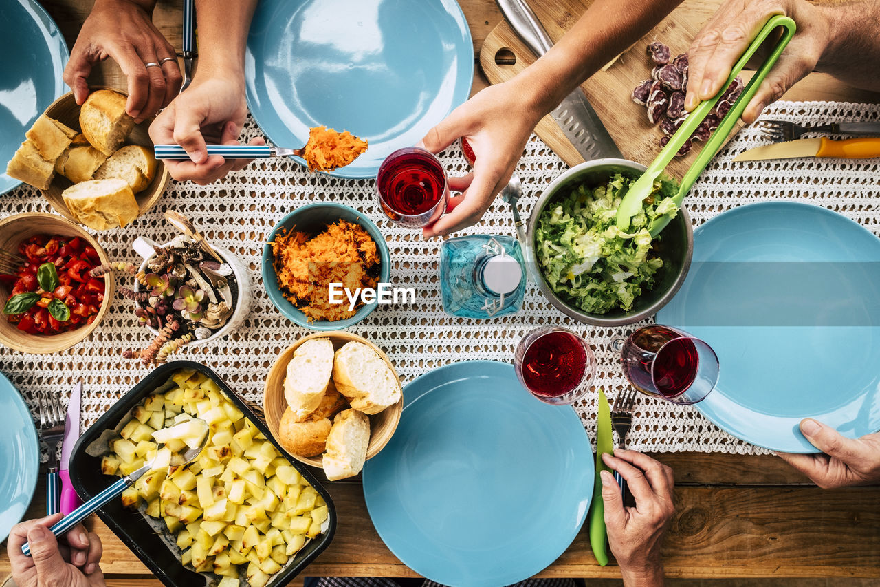 Directly above shot of people hand eating food on table