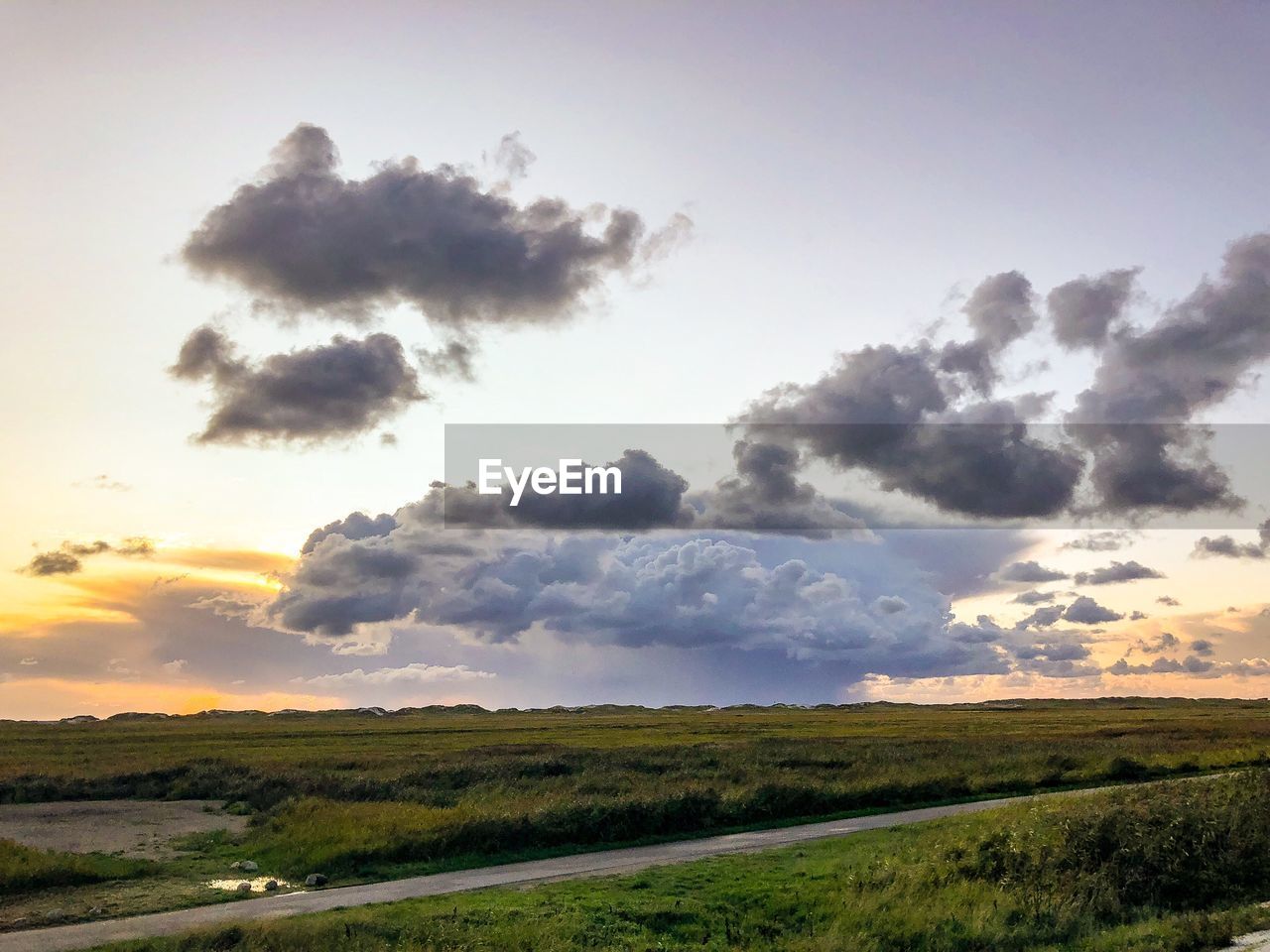 Scenic view of field against sky during sunset