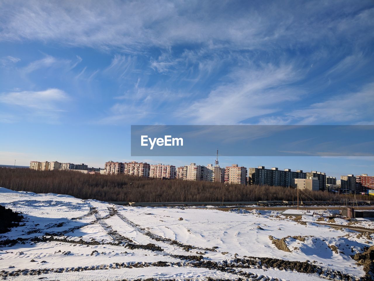 SNOW COVERED BUILDINGS AGAINST SKY