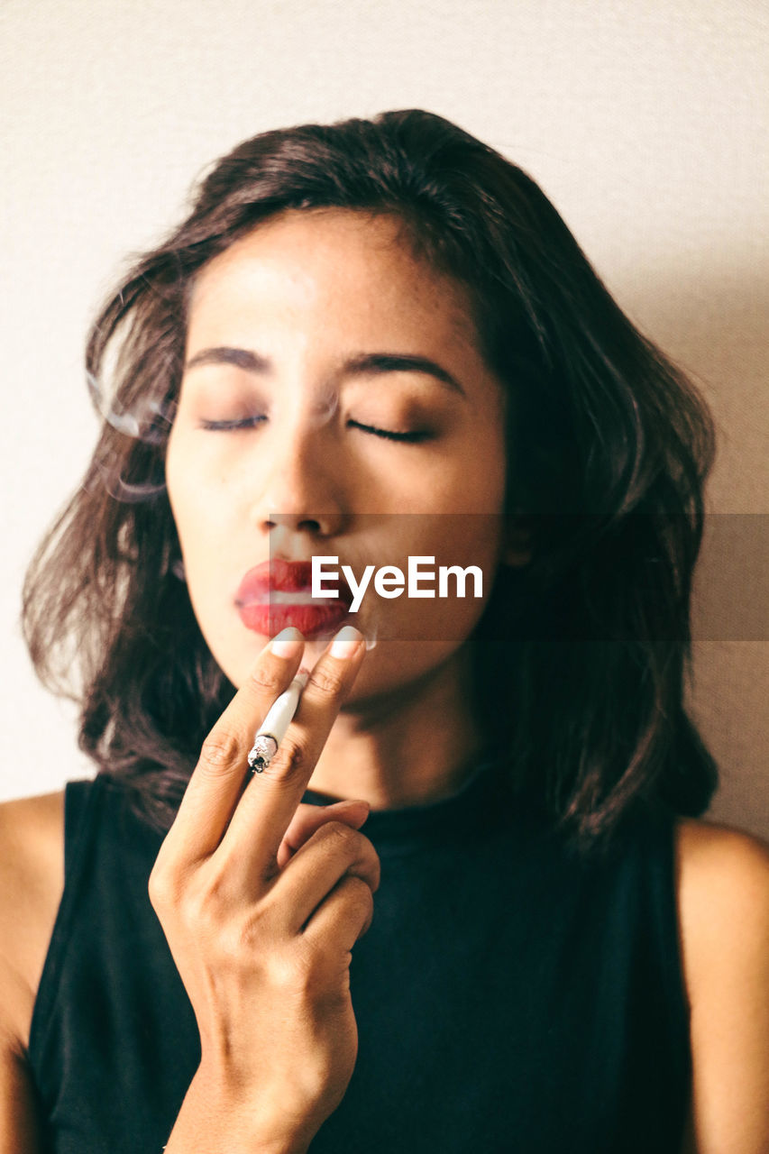 Close-up of young woman smoking