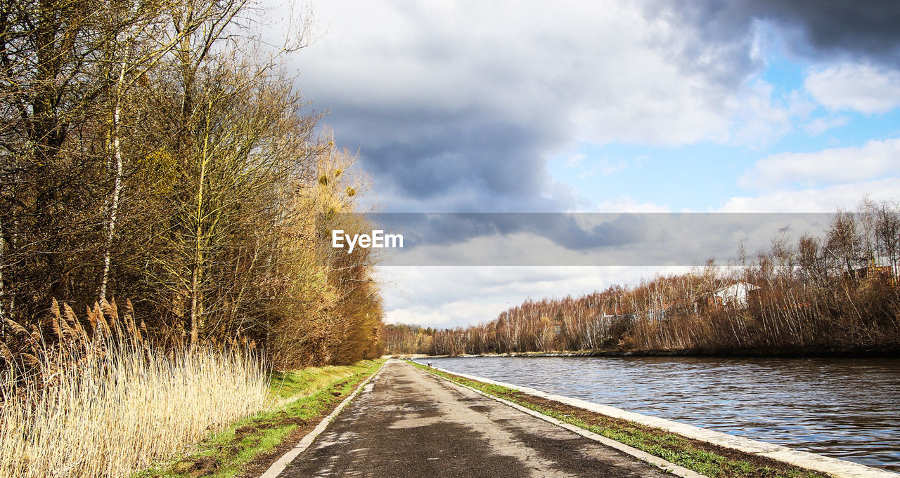 nature, plant, autumn, tree, sky, morning, cloud, rural area, road, landscape, the way forward, transportation, grass, no people, beauty in nature, river, scenics - nature, environment, tranquility, diminishing perspective, day, water, winter, tranquil scene, sunlight, non-urban scene, land, vanishing point, reflection, outdoors, country road, waterway, forest, travel, leaf, footpath, infrastructure, travel destinations, rural scene, empty road