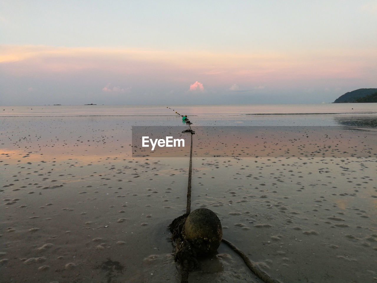 SCENIC VIEW OF BEACH AGAINST SKY DURING SUNSET