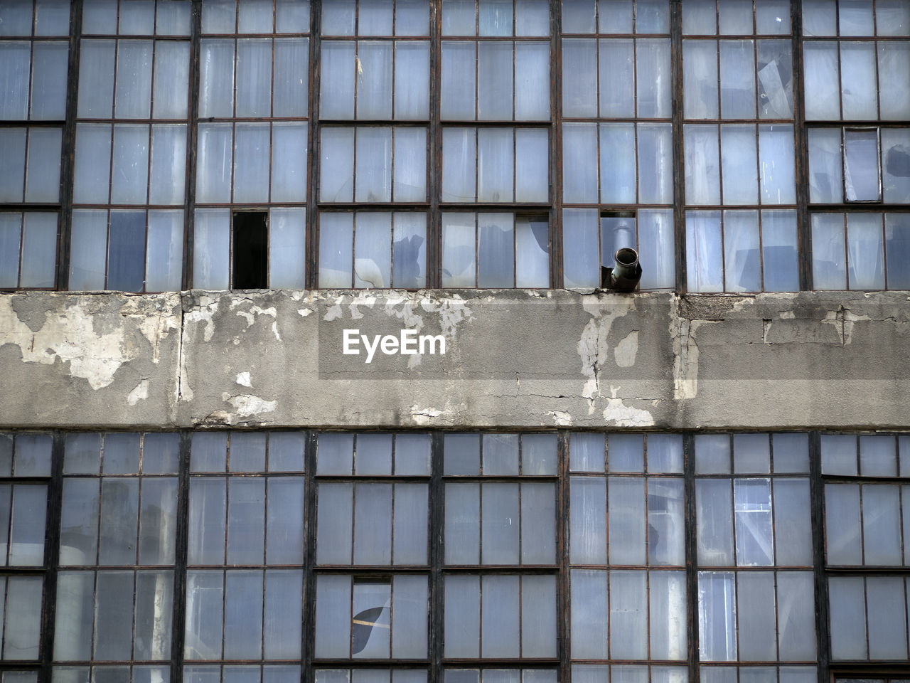 Broken windows in an abandoned industrial building