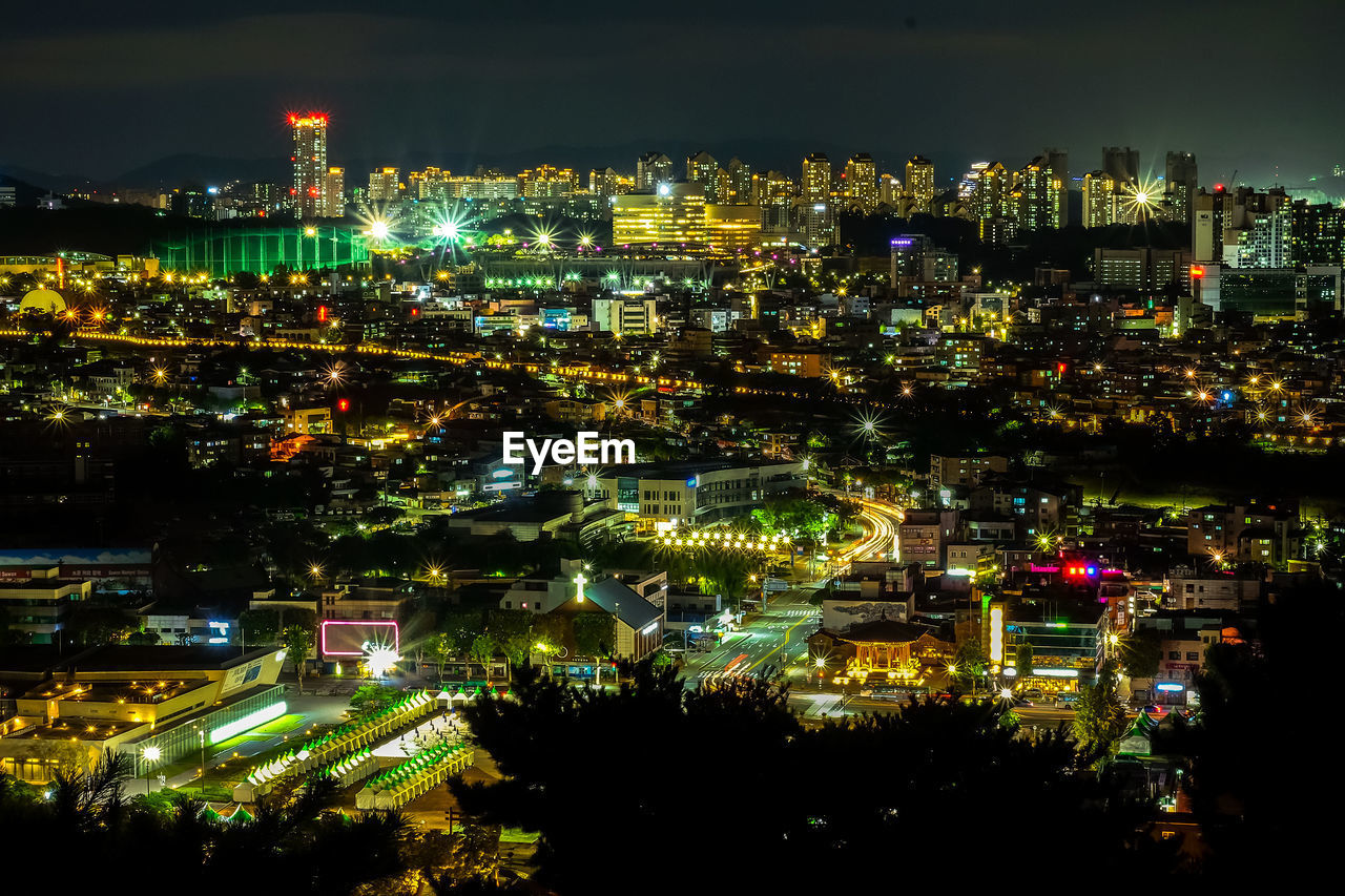 Aerial view of city lit up at night