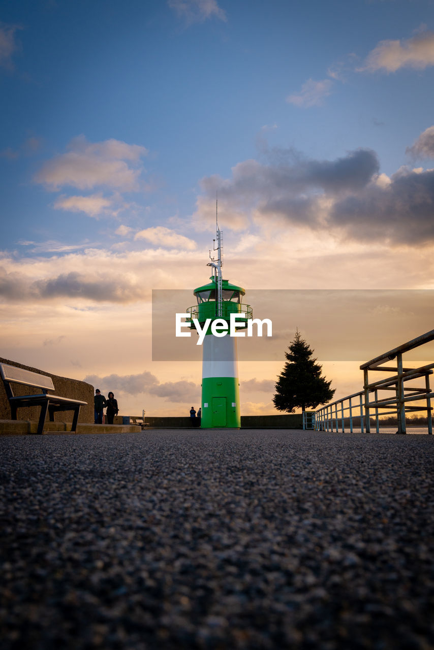 sky, lighthouse, architecture, built structure, guidance, cloud, tower, building exterior, nature, security, horizon, dusk, beach, protection, building, evening, sea, sunset, water, land, blue, no people, travel destinations, light, outdoors, observation tower, ocean, reflection, coast, transportation, travel, city, sunlight