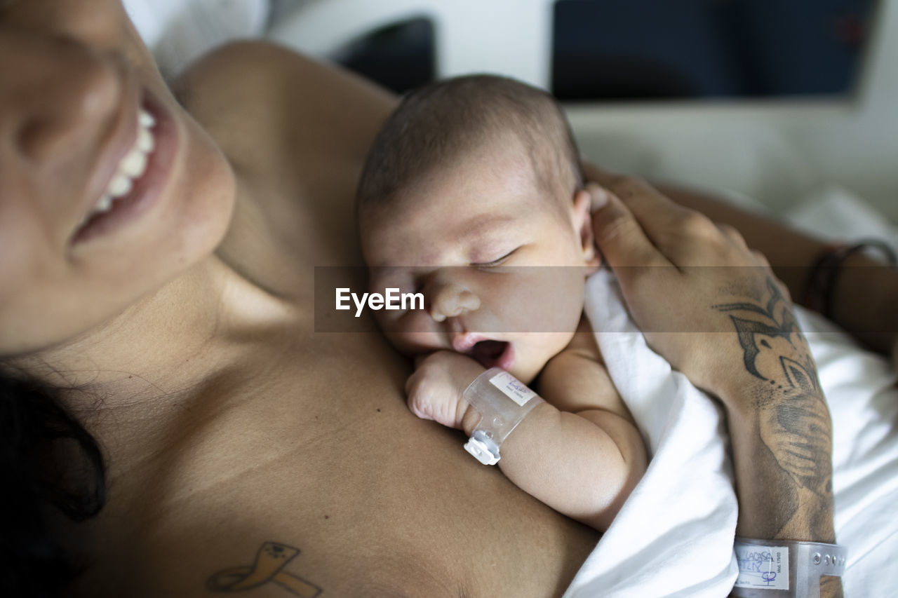 High angle view of newborn sleeping in  the hospital with mum