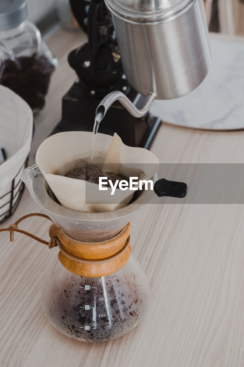 HIGH ANGLE VIEW OF COFFEE CUP ON TABLE AT HOME