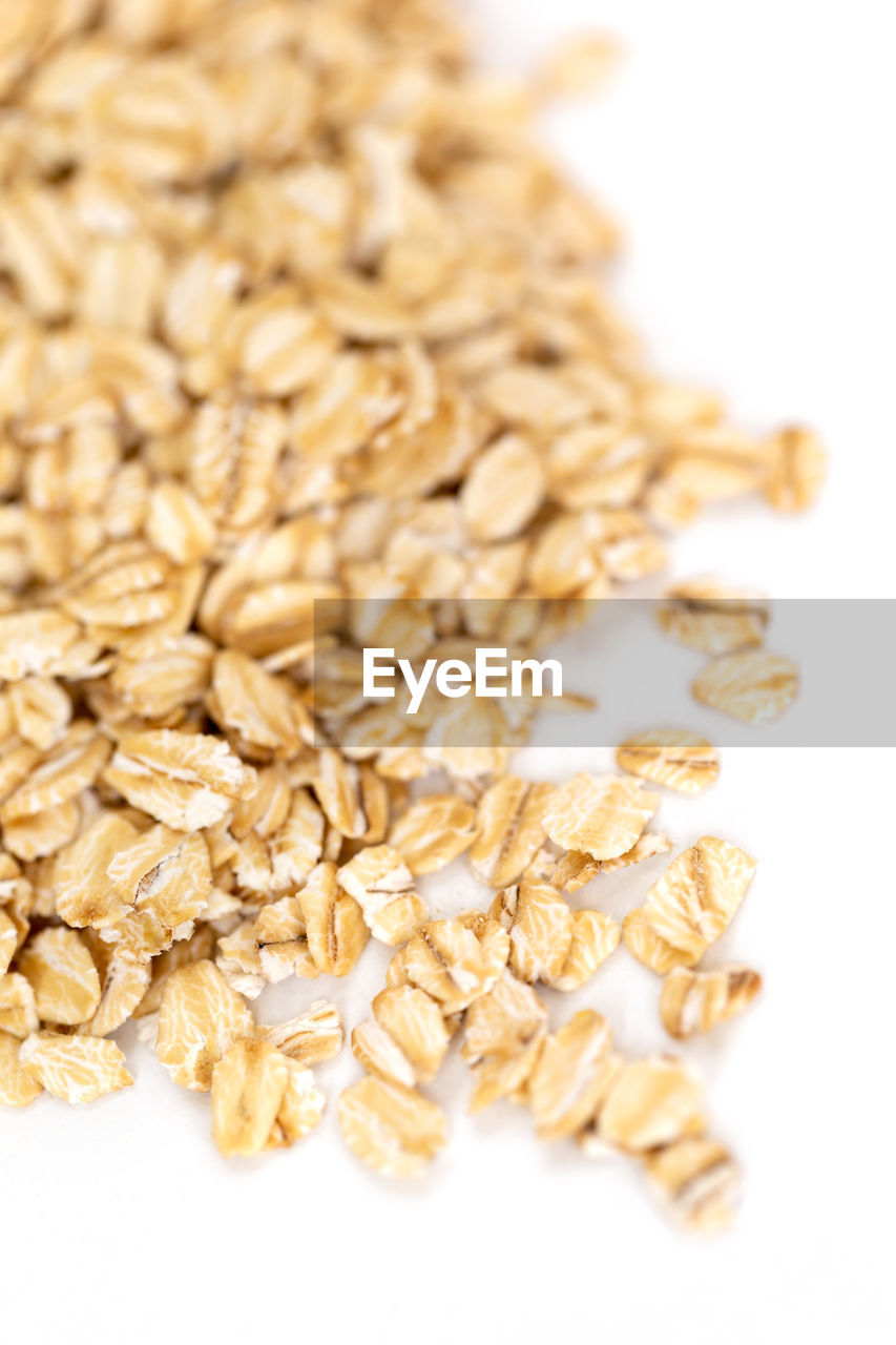 Heap of whole organic oats isolated on white background