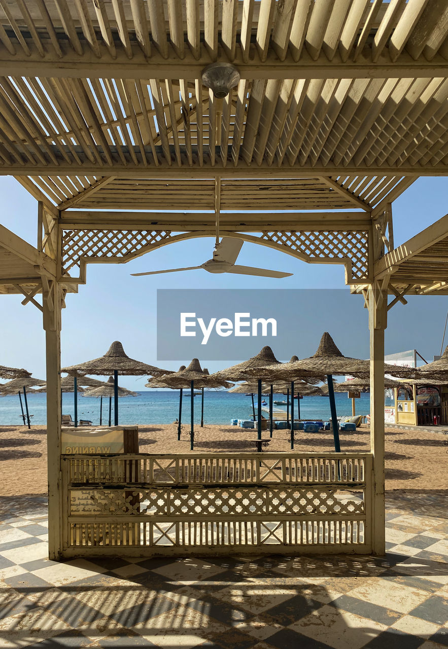 Built structure on beach against sky