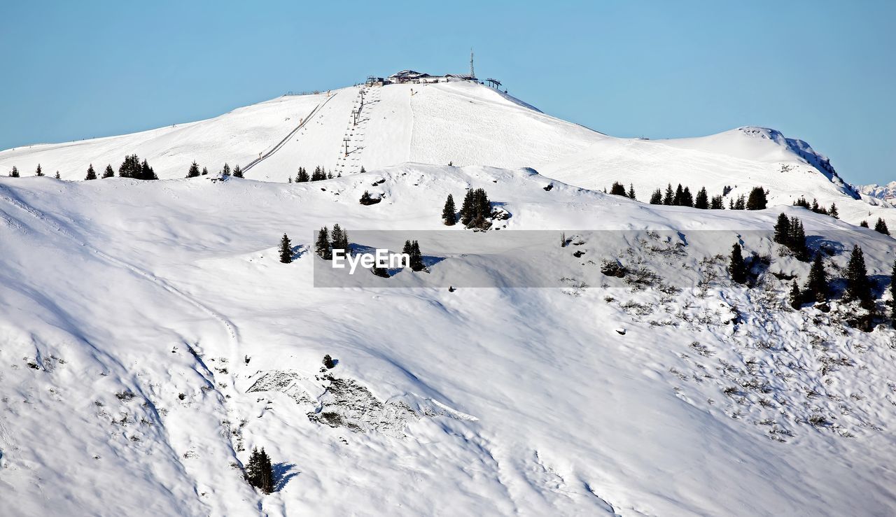 Snow alp summit in austria in sunny winter