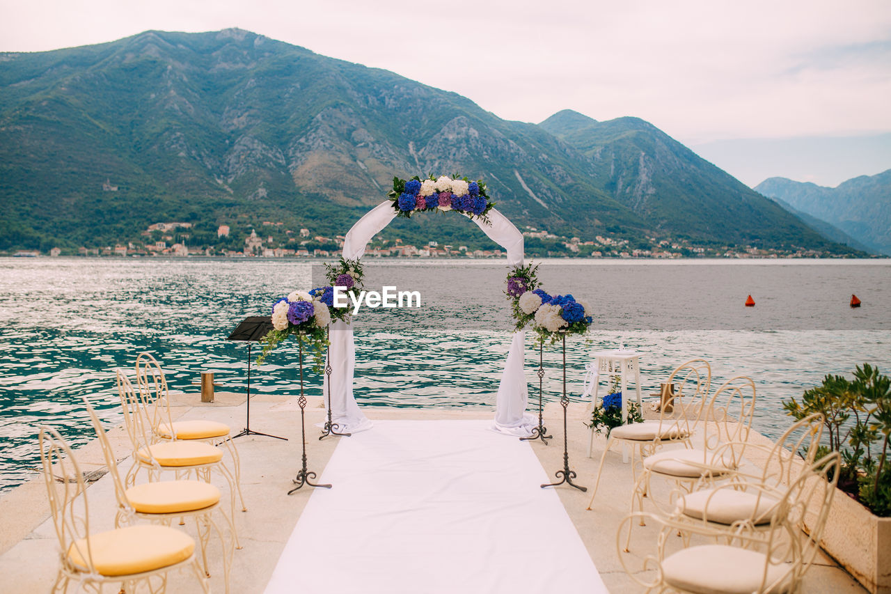 Empty wedding area near sky against mountains