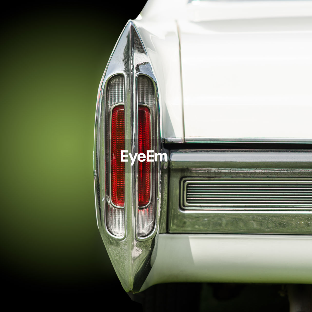 CLOSE-UP OF VINTAGE CAR ON WHITE BACKGROUND