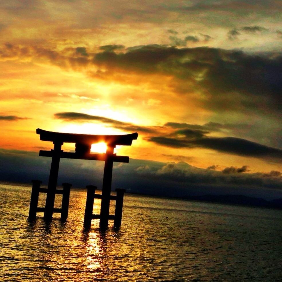 Torii gate in lake during sunset