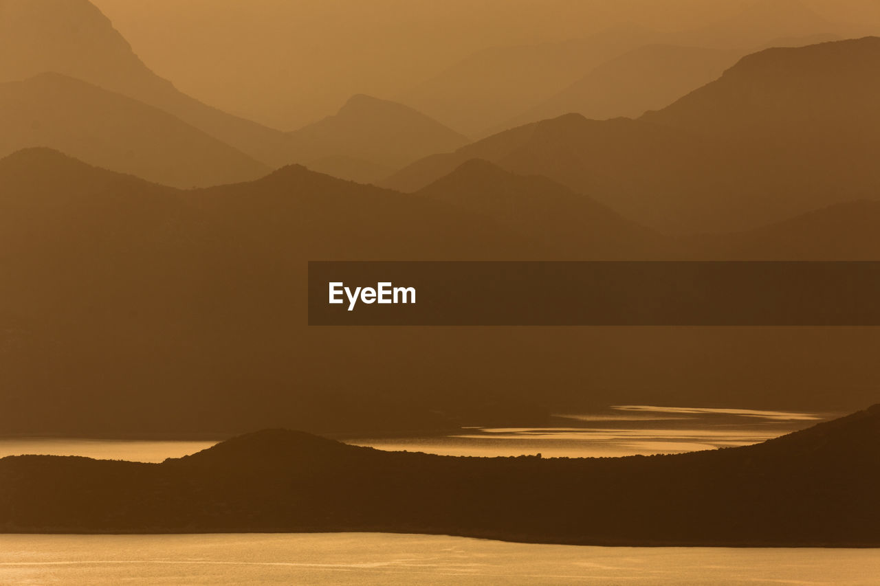 Scenic view of silhouette mountains against sky during sunset