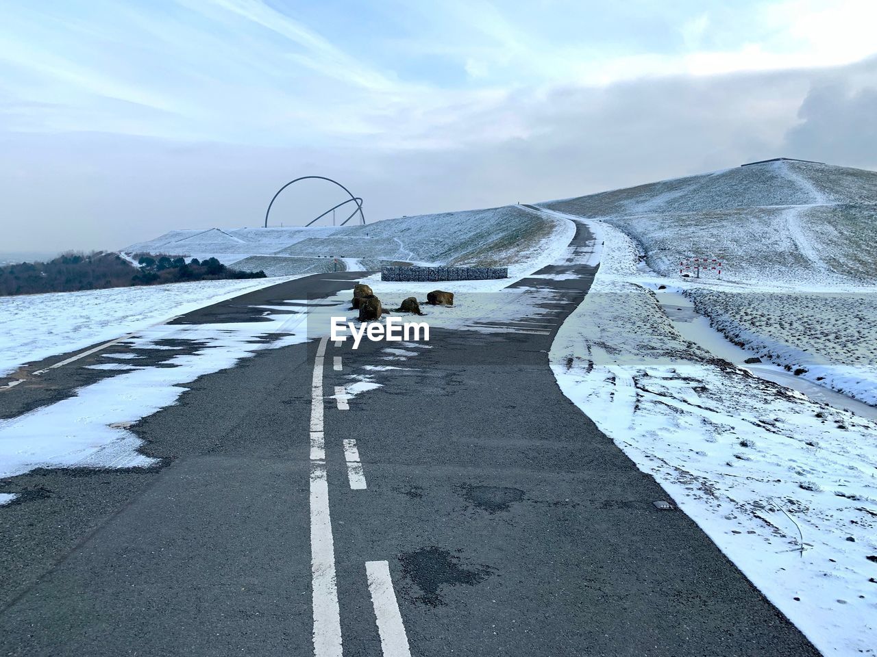 Scenic view of road against sky during winter