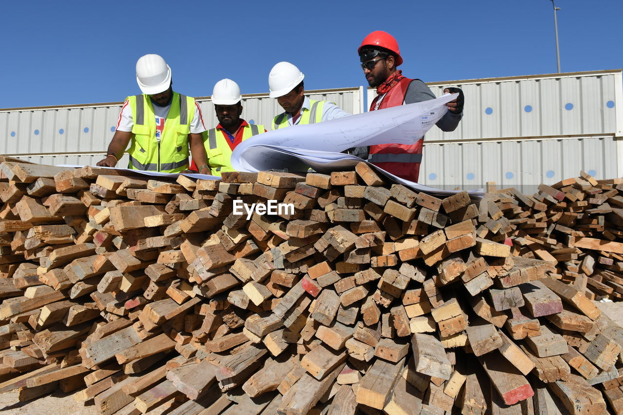 Engineers working over blueprint