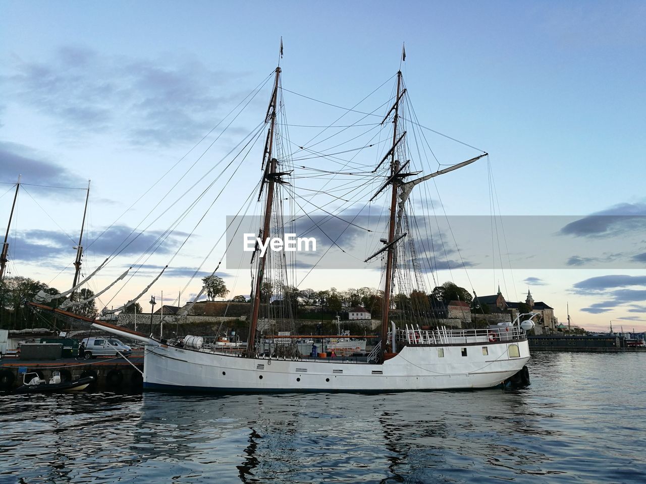 SAILBOATS MOORED IN SEA