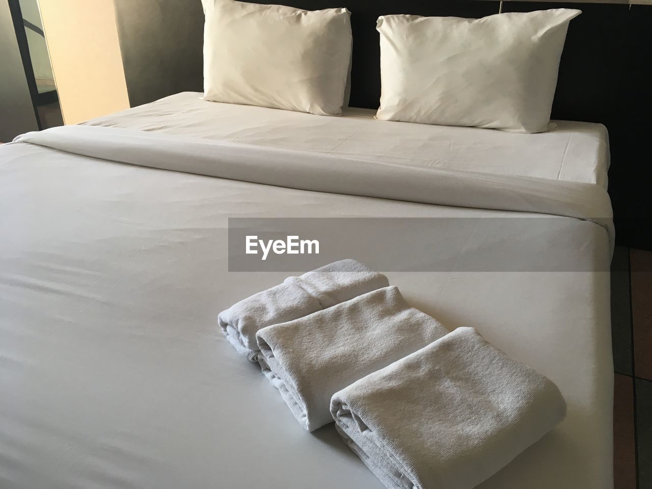 High angle view of folded towels on bed in hotel room