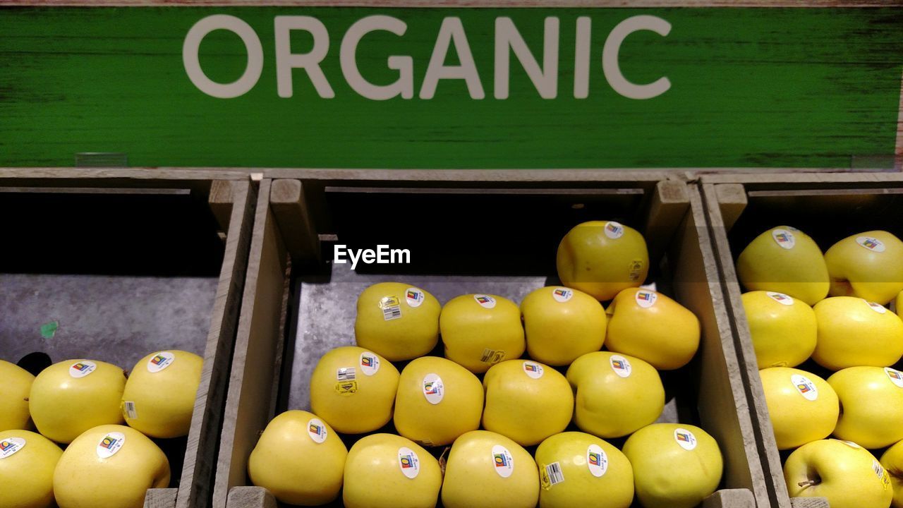 High angle view of apples in container at market for sale