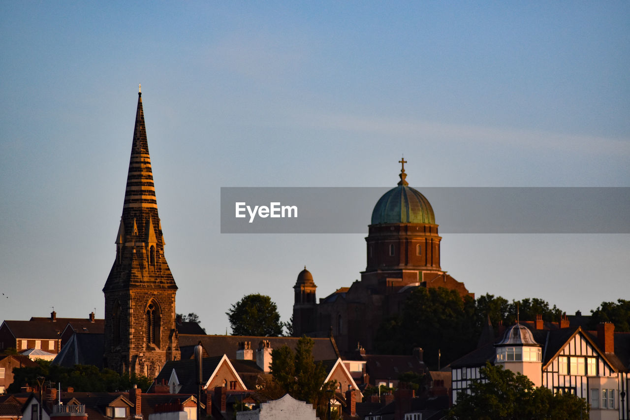 Cathedral of buildings against sky in city