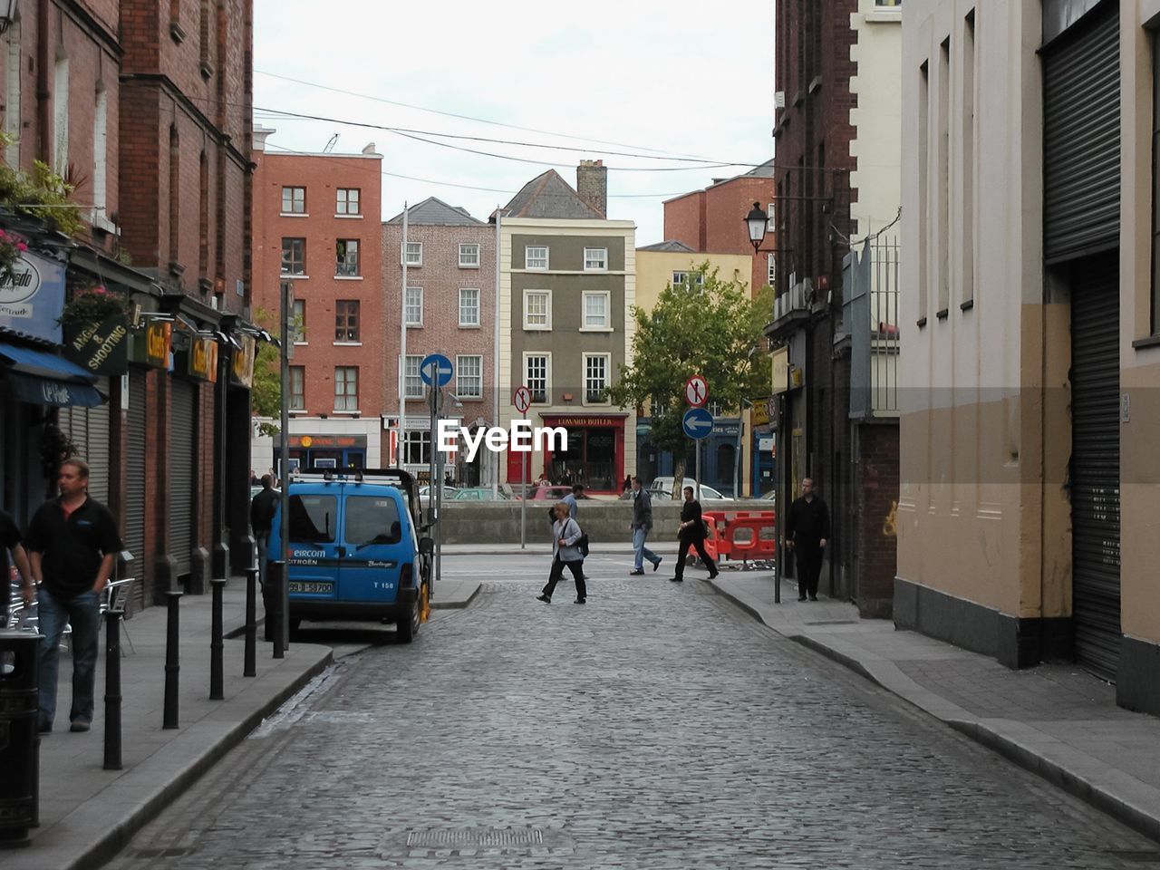 PEOPLE ON ROAD ALONG BUILDINGS