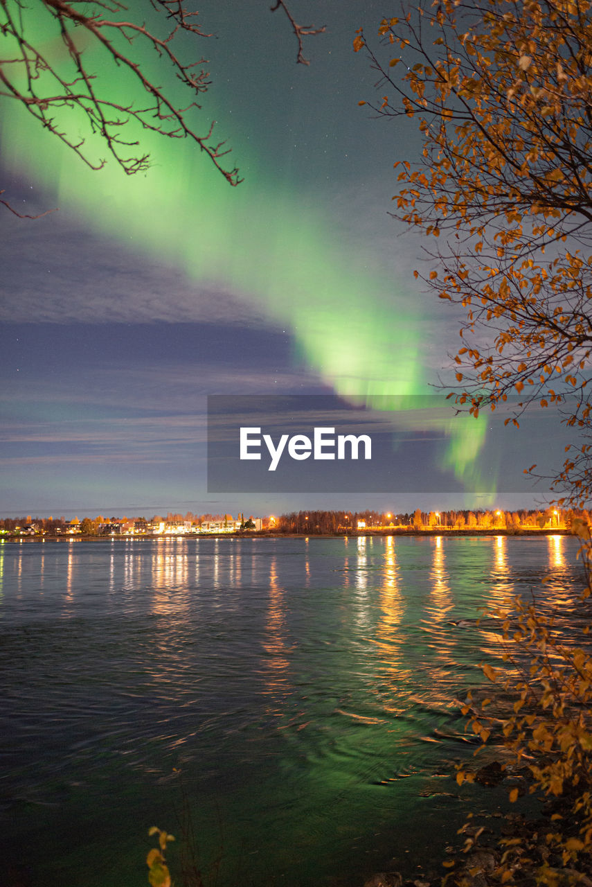 Scenic view of river against sky during aurora borealis