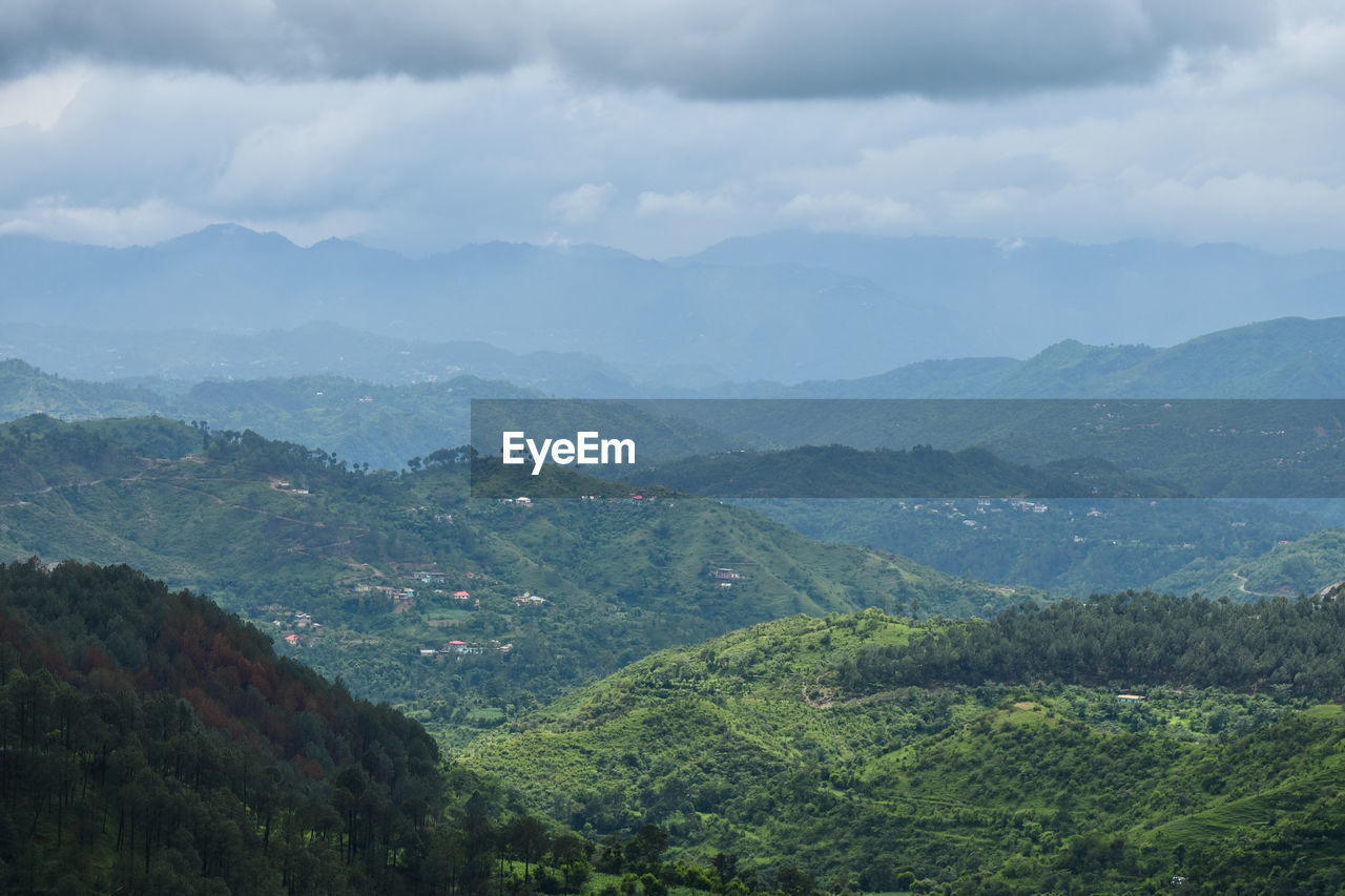 Scenic view of mountains against cloudy sky