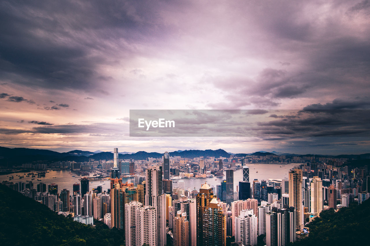 High angle view of modern buildings against sky during sunset