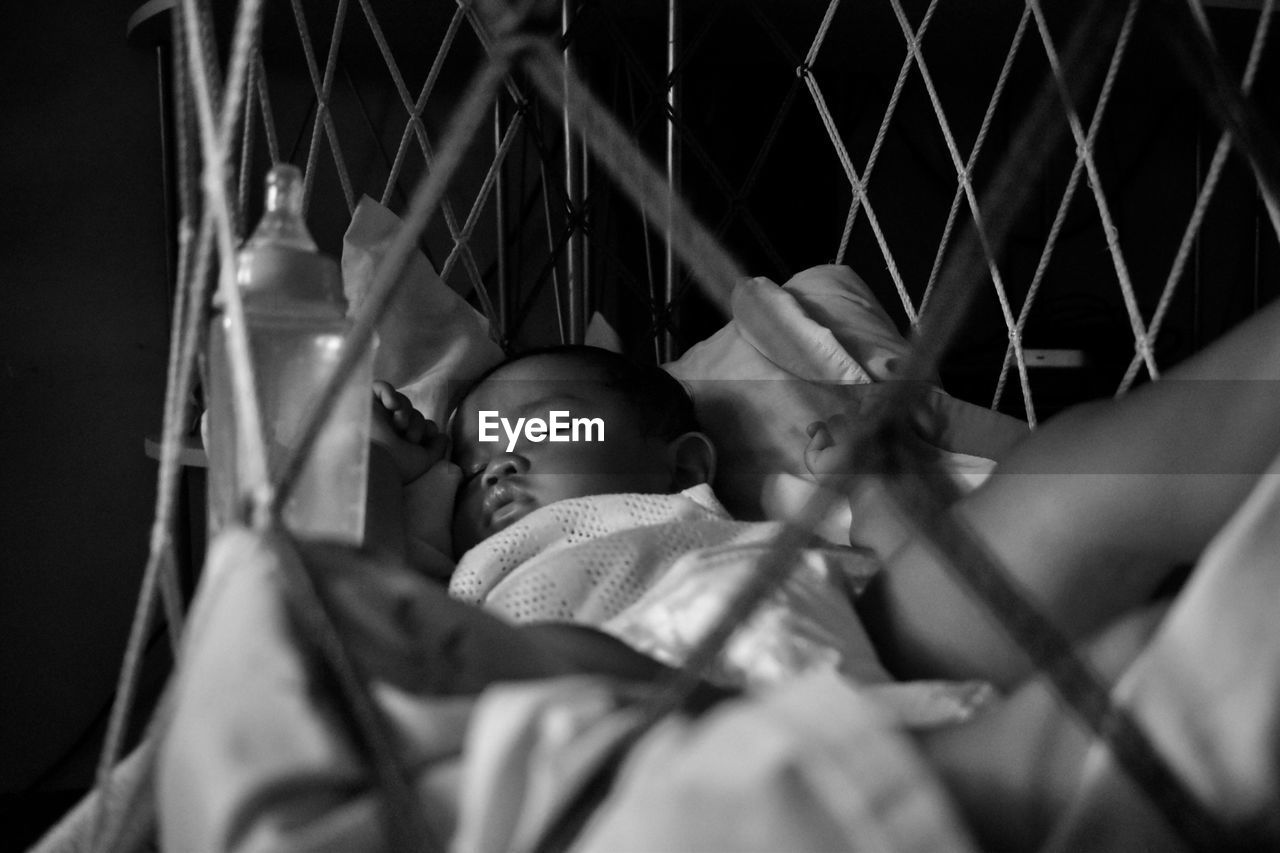 Baby boy sleeping in crib