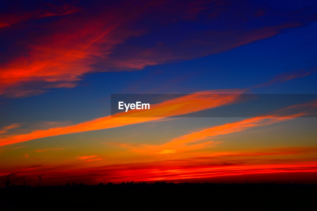 SCENIC VIEW OF SILHOUETTE LANDSCAPE AGAINST DRAMATIC SKY