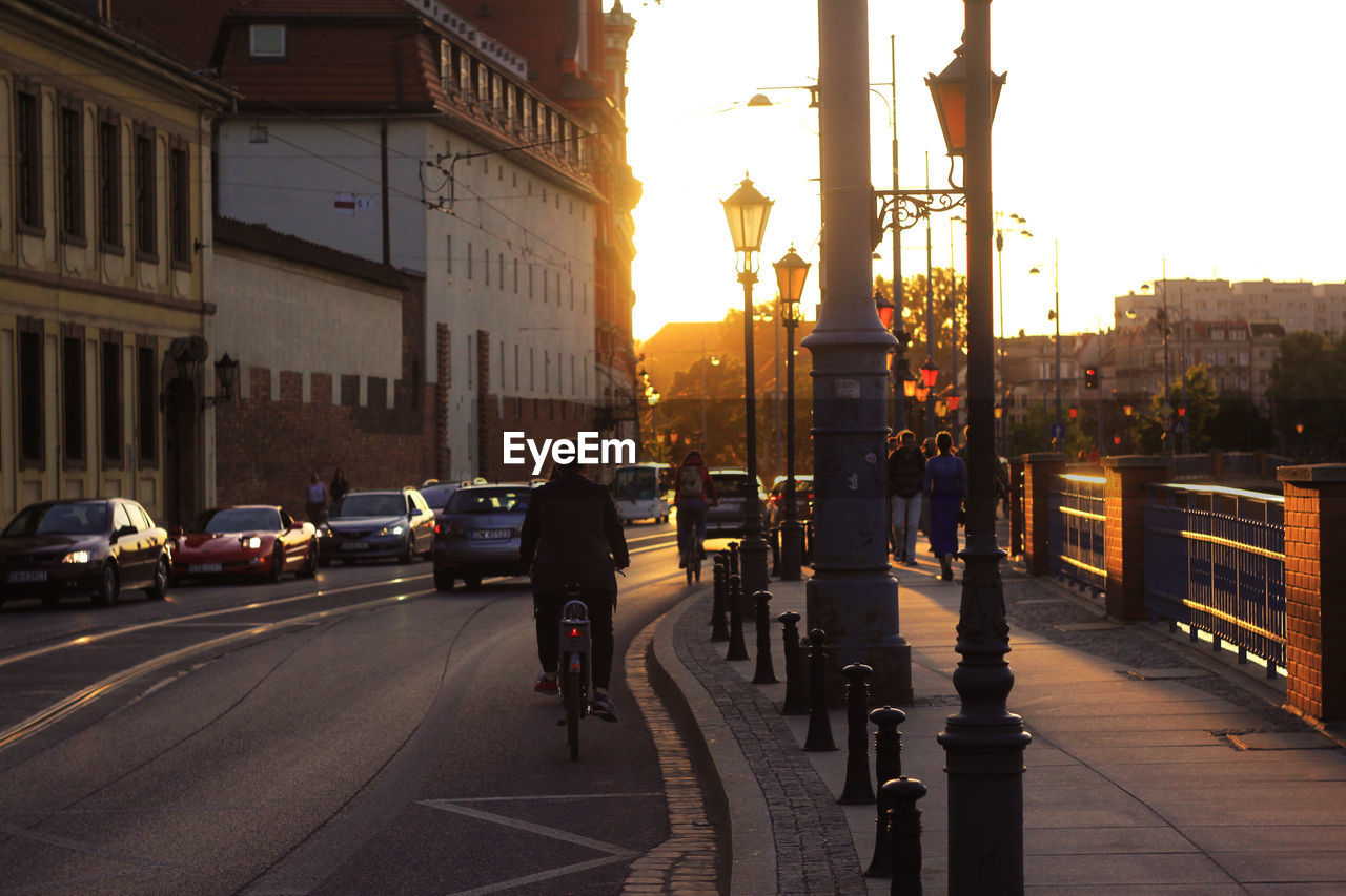 People on city street at sunset