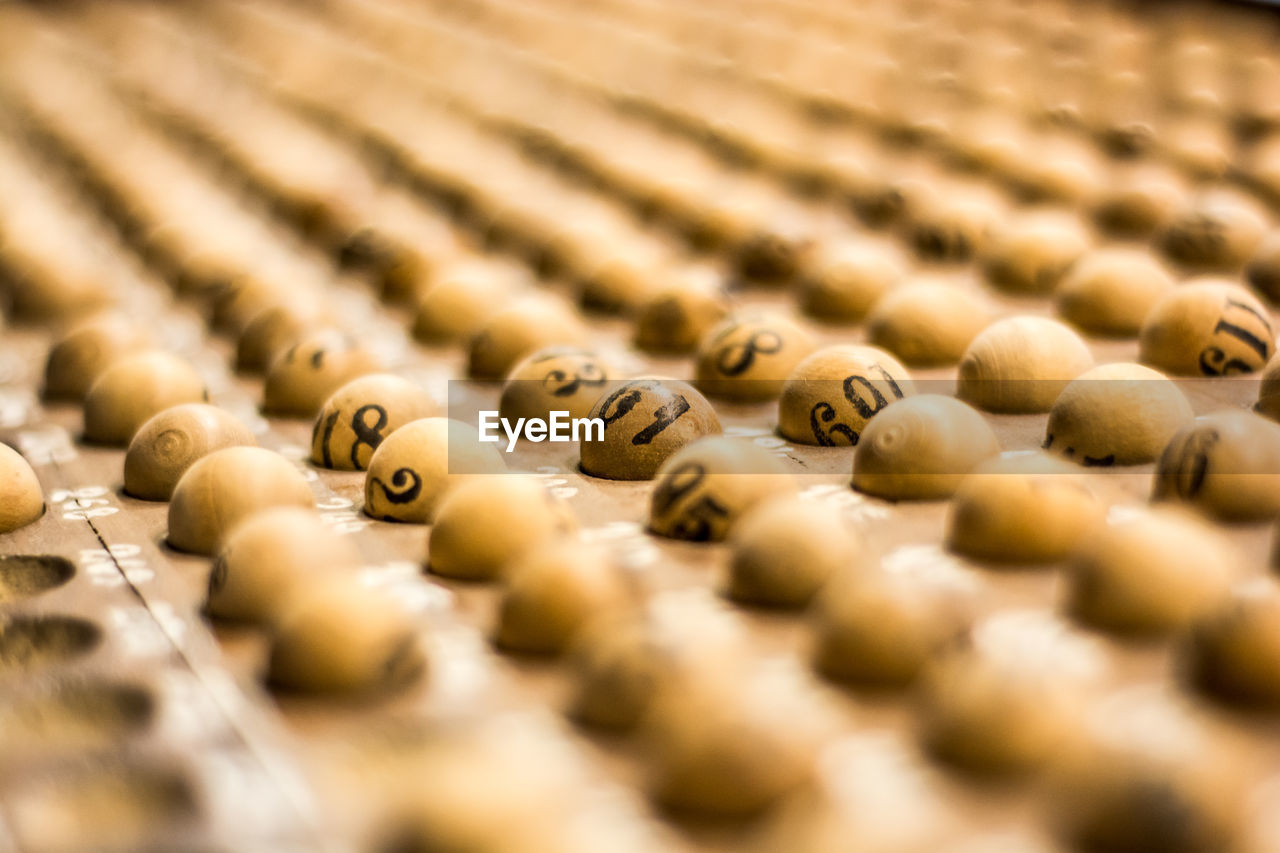 Close-up of wooden lottery balls on tray