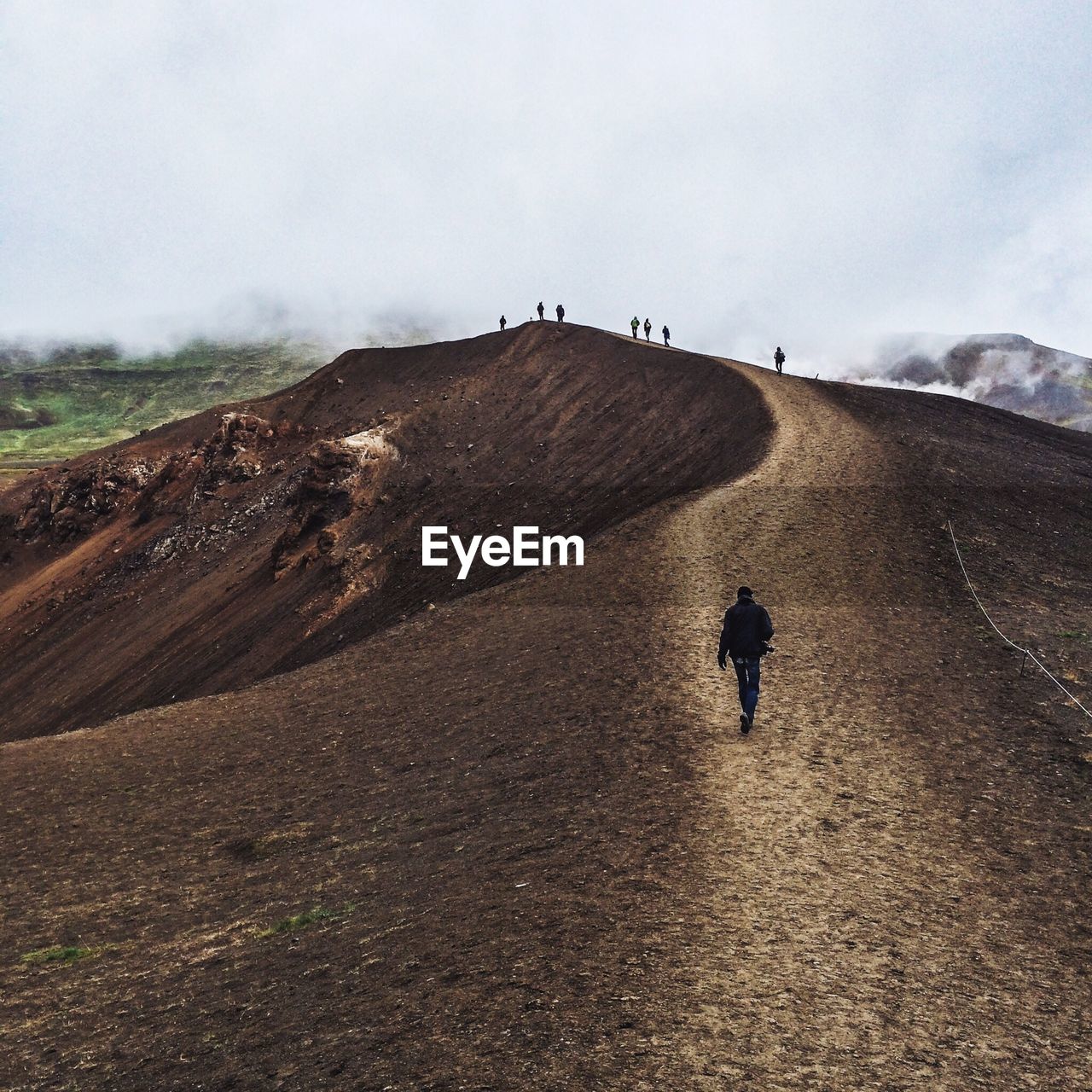 People hiking on mountains in foggy weather