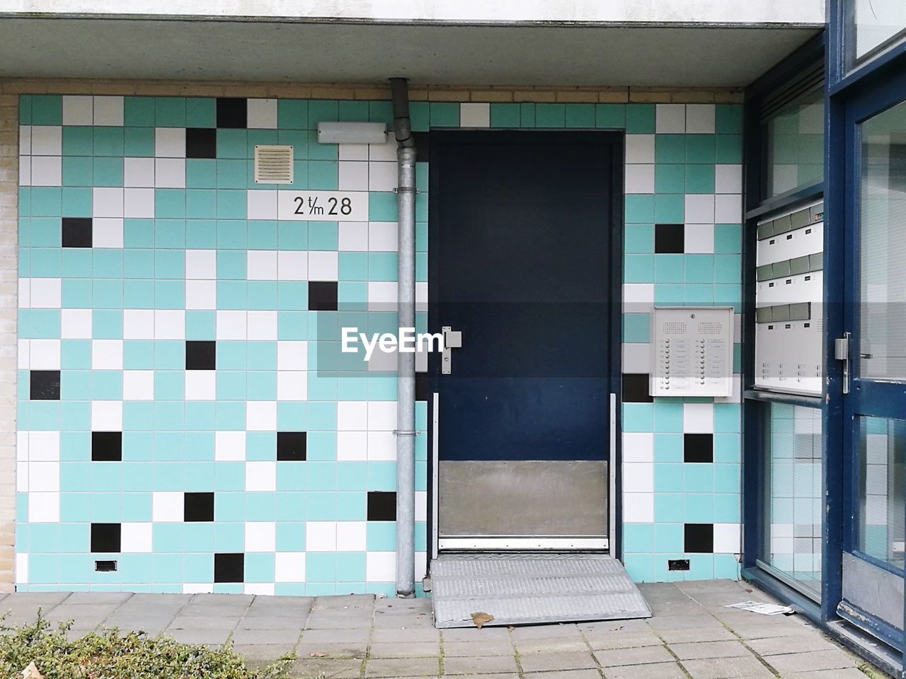 OPEN DOOR OF BUILDING WITH WINDOWS