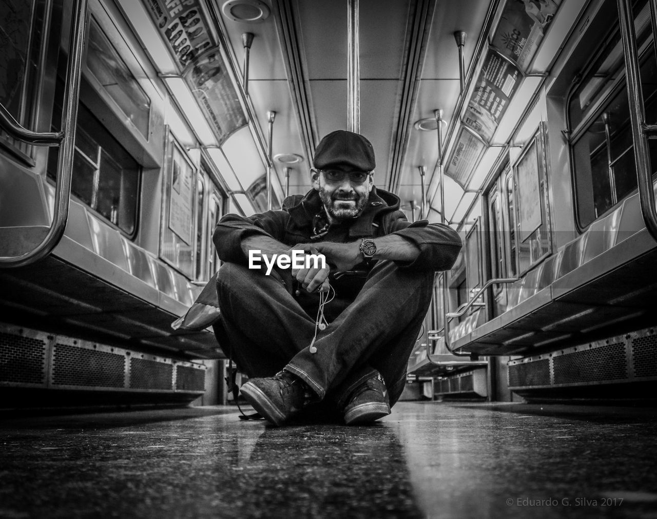 Full length of man sitting in subway train