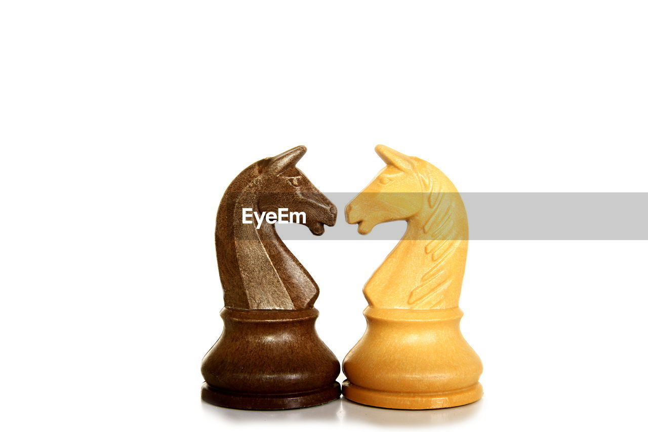 Close-up of chess pieces against white background