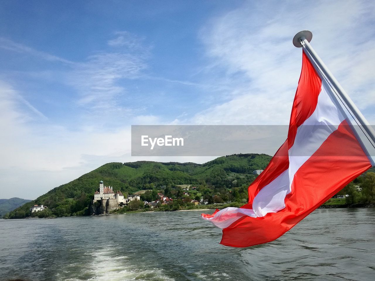 RED FLAG IN LAKE AGAINST SKY