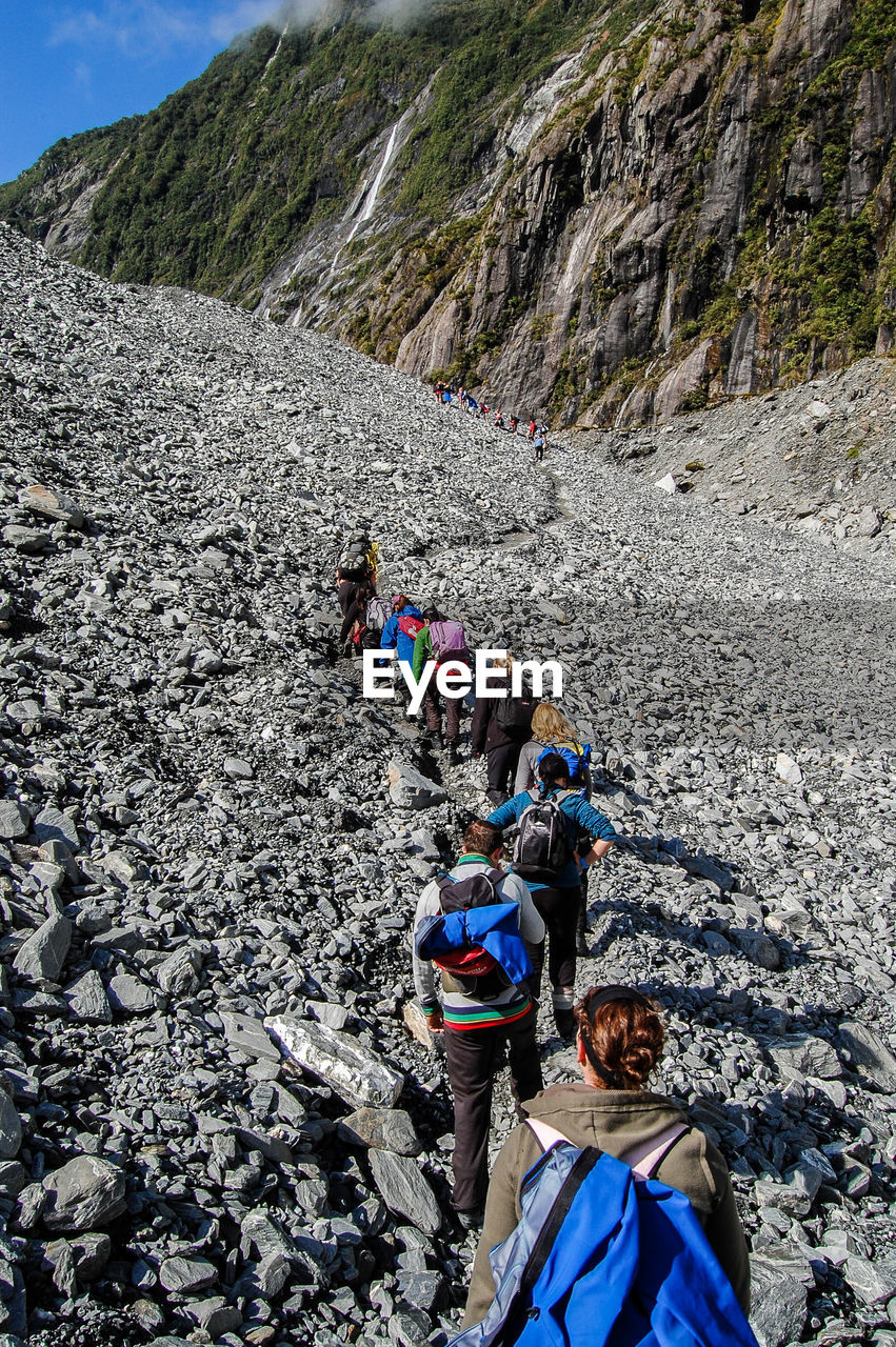 High angle view of people hiking on mountain