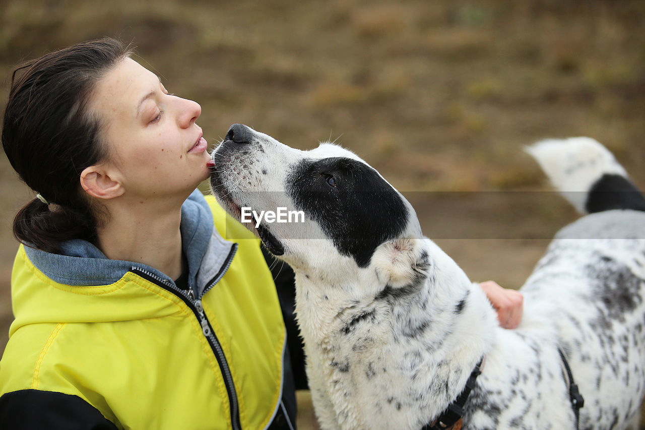 Side view of woman with dog