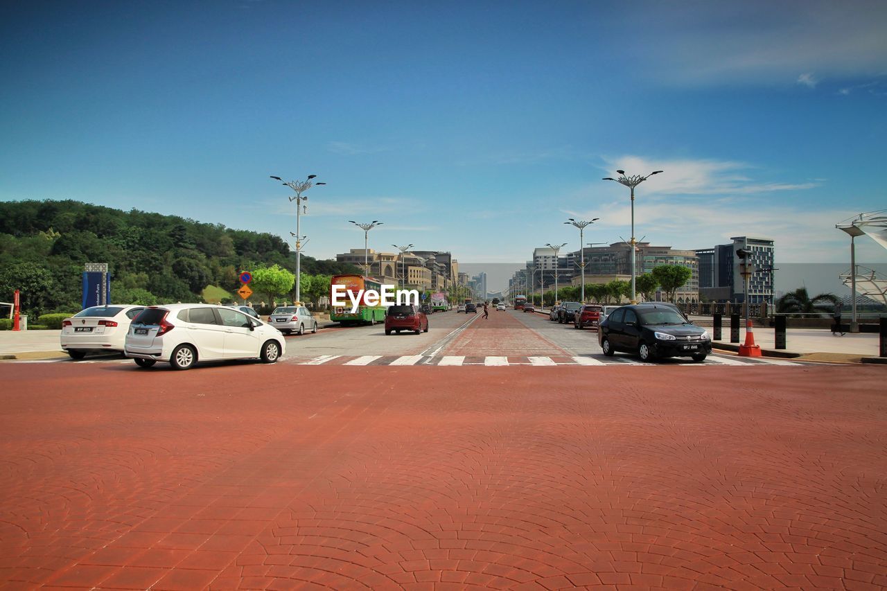 CARS ON ROAD IN CITY