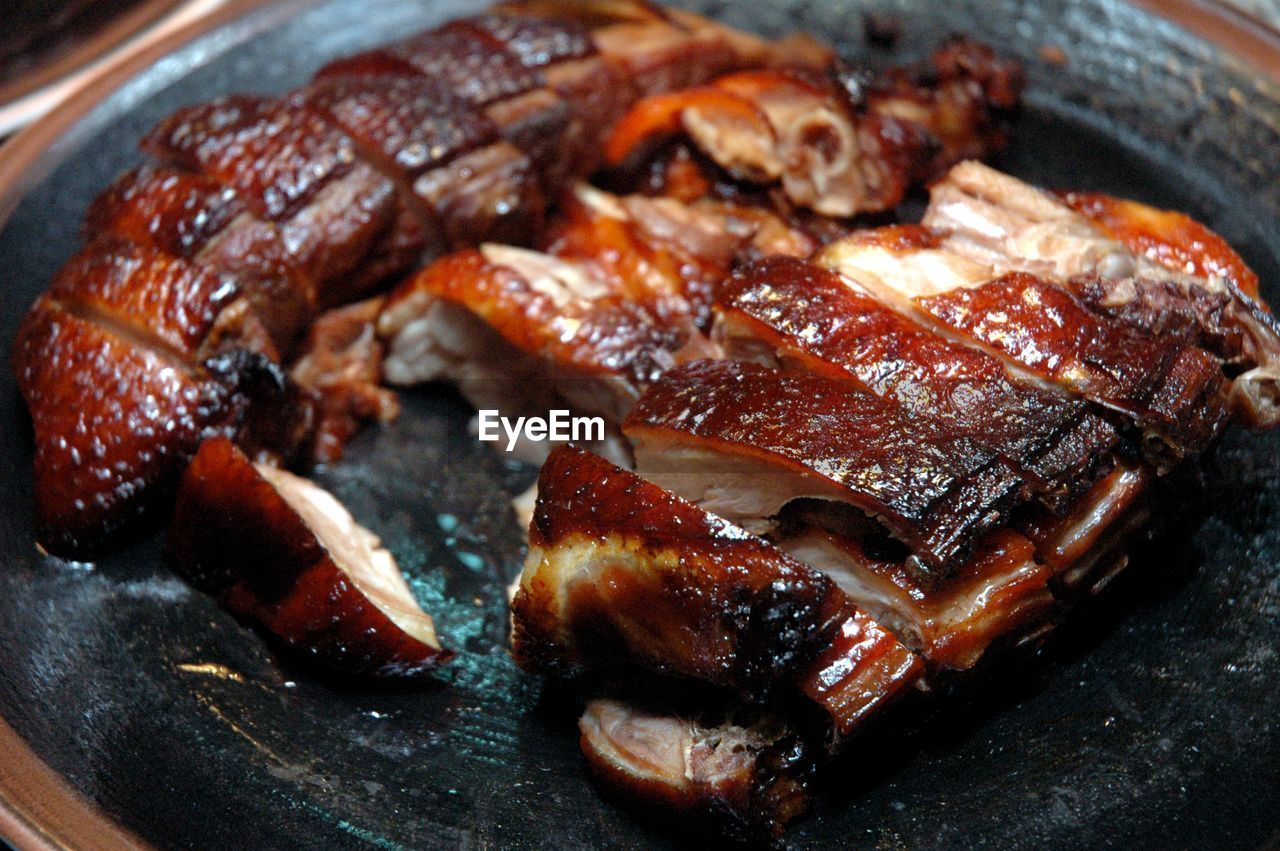 CLOSE-UP OF MEAT ON BARBECUE