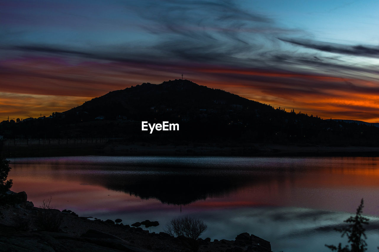 Scenic view of lake against sky during sunset