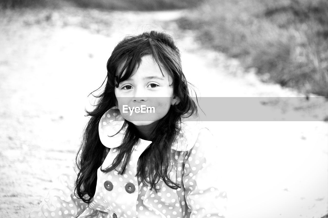 Portrait of cute girl on field