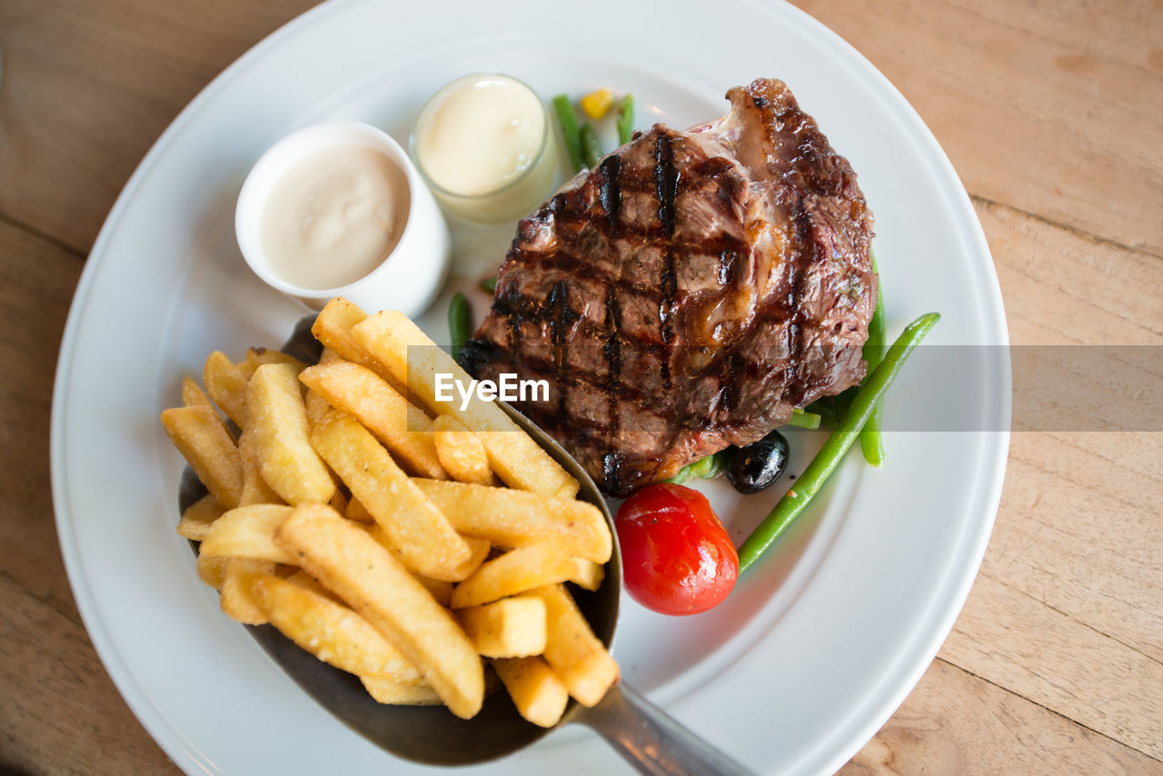 High angle view of food served in plate on wooden table