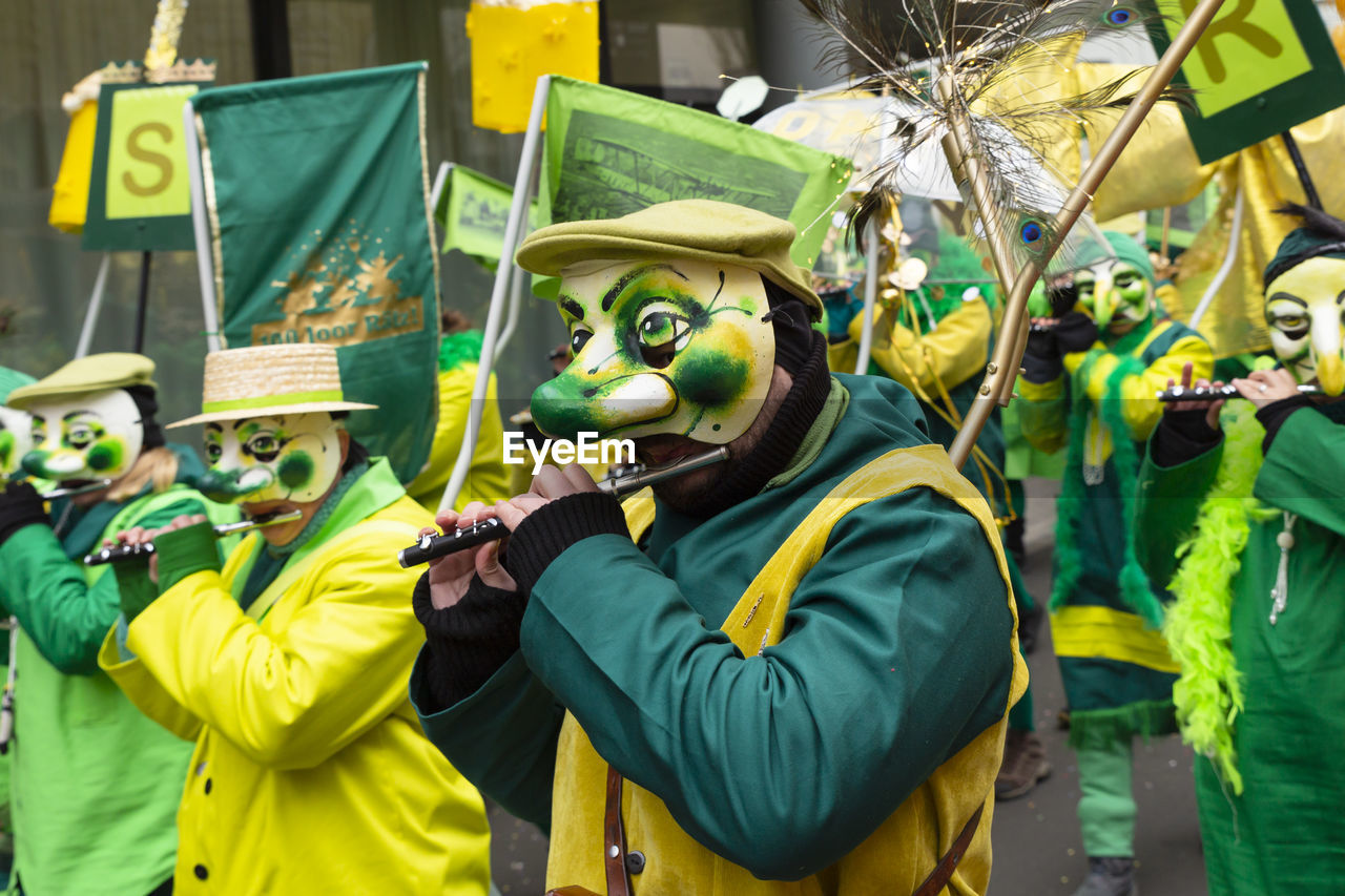Basel, switzerland - march 1st 2023. group of carnival participants playing piccolo flute