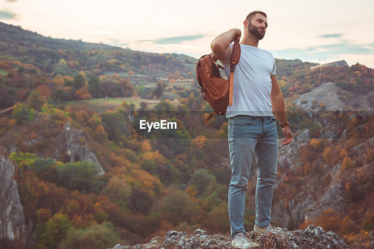 Man standing on rock against mountain