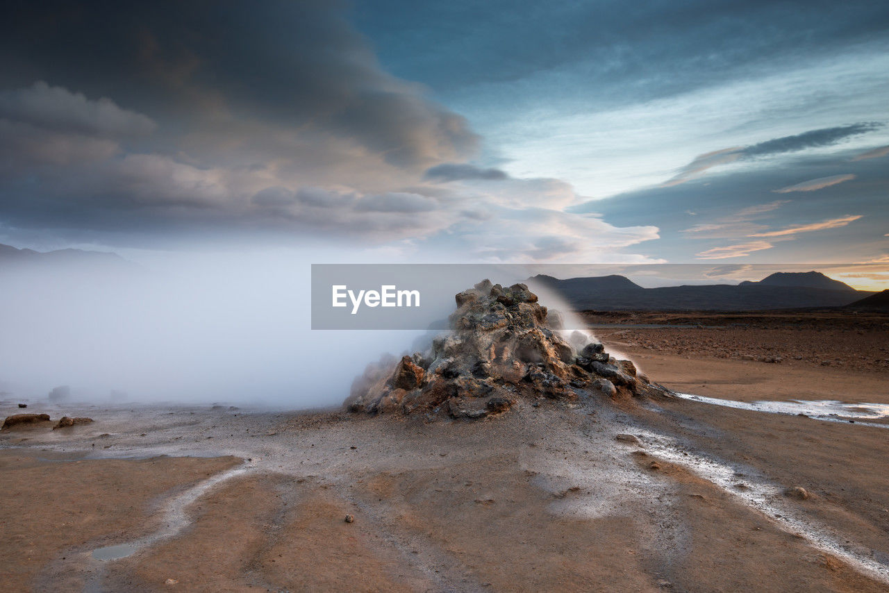 cloud, sky, environment, landscape, land, scenics - nature, sea, beauty in nature, mountain, nature, water, dramatic sky, rock, coast, wave, no people, travel destinations, travel, geology, horizon, non-urban scene, outdoors, accidents and disasters, tranquility, sunlight, sand, morning, beach, storm, ocean, shore, cloudscape, tourism, power in nature, volcano, dramatic landscape